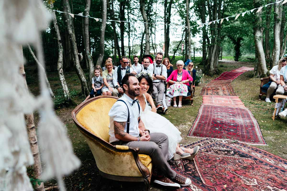 couple in woods on yellow sofa getting married